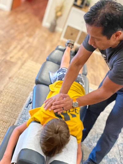Amyas Kabir Adjusting A Boy in Yellow Shirt