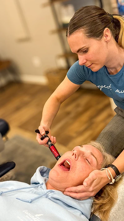 Natalee Olson Using Instrument on Patient's Jaw for TMJD